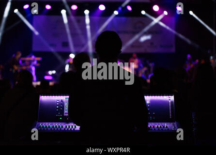 Audio engineer working on a live event Stock Photo