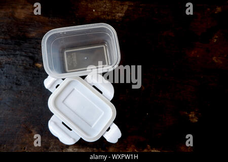 Empty plastic boxes for food storage On black wood floor Stock Photo