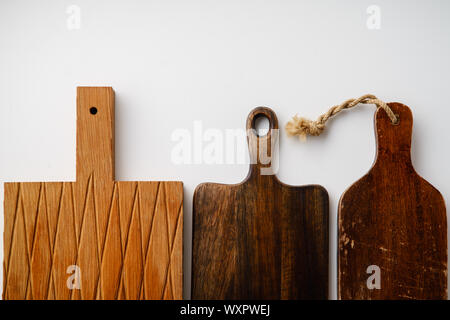 Various wooden tableware. Cutting boards on white background with copy space Stock Photo