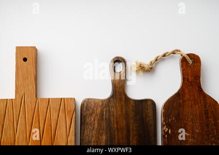 Various wooden tableware. Cutting boards on white background with copy space Stock Photo