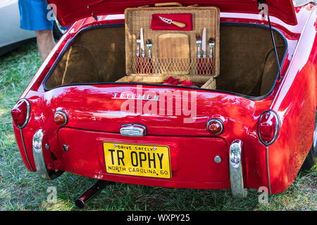 HICKORY, NC, USA-7 SEPT 2019: 1960 Triumph TR3A sports car, red, view from rear showing open trunk with open picnic basket. Stock Photo
