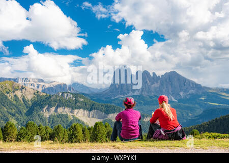 Sporty Young woman friends on mountain trail Dolomites Mountains, Italy. Sport, success, inspiration Stock Photo
