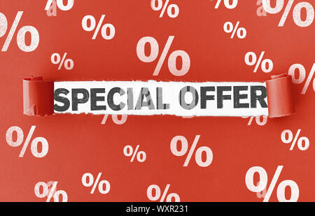white percent signs on torn red paper with text SPECIAL OFFER in opening Stock Photo