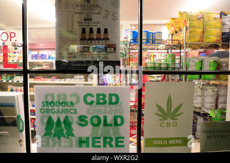 Advertising signs of CBD sold here on a grocery store window in Provincetown.Cape Cod. Massachusetts.USA Stock Photo