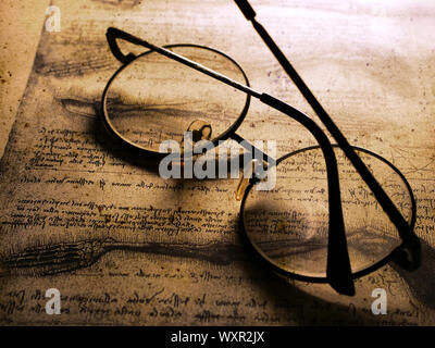 Close up of old classic spectacles on a book background Stock Photo