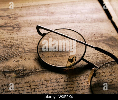 Close up of old classic spectacles on a book background