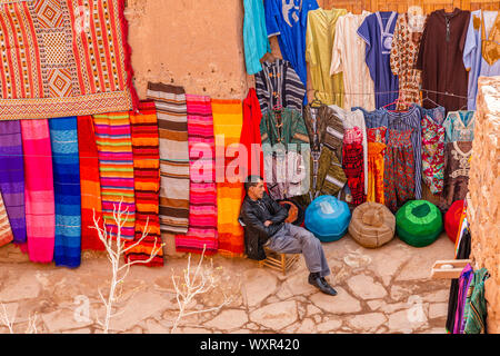 Colourful rugs and carpets hand made in patterns and designs of an Arabic traditional craft by local artisans in a Moroccan market close to Marrakesh Stock Photo