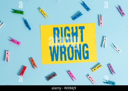 Handwriting text Right Wrong. Conceptual photo choose between two decisions correct and bad one to make Colored clothespin rectangle shaped reminder p Stock Photo