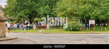 A panoramic view of a village street party / fete on the green in Welby, Lincolnshire, England. A well attended local community spirit event. Stock Photo