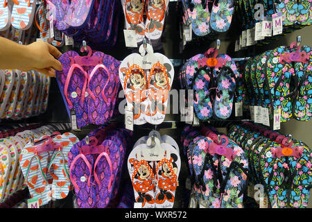 Disney motif decorated flip flops in a shop Stock Photo