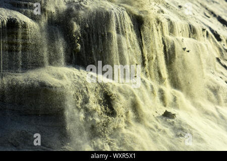Sandy slope with layered texture taken closeup as abstract background. Stock Photo