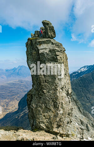 A climber at the top of the Inaccessible Pinnacle, at the summit of Sgurr Dearg, Cuillin mountains, Minginish, Isle of Skye, Scotland, UK Stock Photo