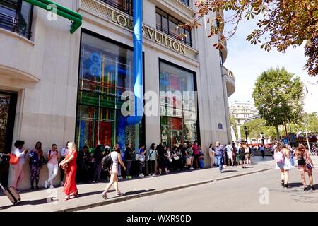 People in line waiting to enter the Louis Vuitton store, Paris, France
