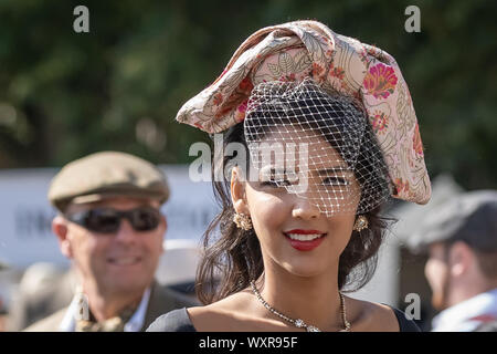 Vintage-themed fashion and other dress variations are worn during Goodwood Revival, Britain’s greatest annual classic car show, UK. Stock Photo