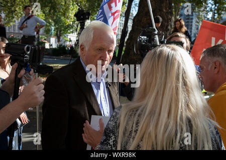 Television presenter and broadcaster David Dimbleby speaks to pro-leave protesters outside The Supreme Court as the first day of the hearing to rule on the legality of suspending or proroguing Parliament begins on September 17th 2019 in London, United Kingdom. The ruling will be made by 11 judges in the coming days to determine if the action of Prime Minister Boris Johnson to suspend parliament and his advice to do so given to the Queen was unlawful. David Dimbleby is a British journalist and former presenter of current affairs and political programmes, now best known for the BBCs long-running Stock Photo