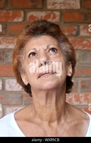 Portrait of an older mixed race woman looking up with stunning brown eyes Stock Photo