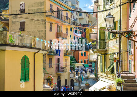 Apartments with balconies line the path through the colorful village of Manarola, Italy, part of the Cinque Terre on the Ligurian Coast. Stock Photo