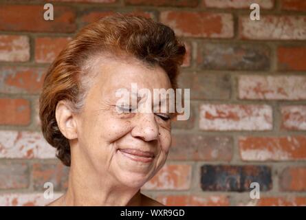 Portrait of a delighted senior woman with her eyes closed Stock Photo