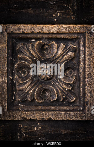 Ancient columns with Renaissance bas-reliefs and plants patterns in the wall Stock Photo