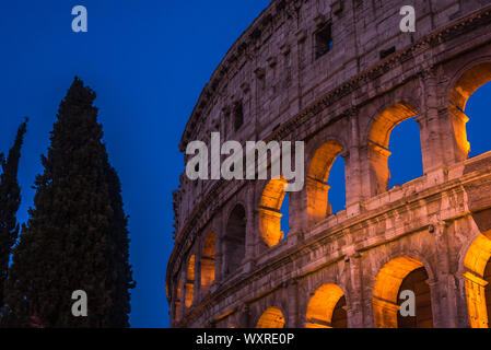 The Colosseum under the glow of lights at night, Rome Stock Photo