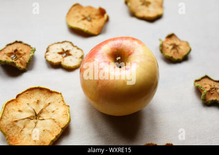 Fresh apple with pieces of dry apples on the table, top view Stock Photo