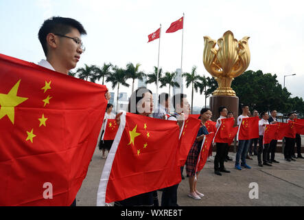 (190917) -- HONG KONG, Sept. 17, 2019 (Xinhua) -- Young people hold up China's national flag during a flash mob in Hong Kong, south China, Sept. 17, 2019. A total of 100 young residents from Hong Kong participated in the flash mob on Tuesday. (Xinhua/Li Gang) Stock Photo