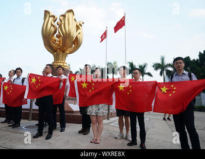 (190917) -- HONG KONG, Sept. 17, 2019 (Xinhua) -- Young people hold up China's national flag during a flash mob in Hong Kong, south China, Sept. 17, 2019. A total of 100 young residents from Hong Kong participated in the flash mob on Tuesday. (Xinhua/Li Gang) Stock Photo