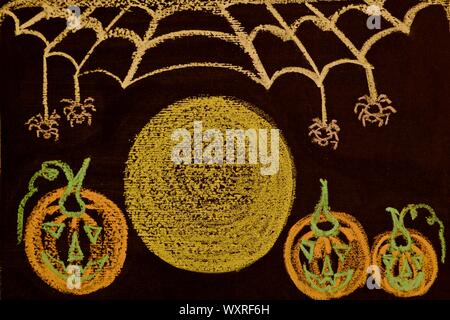 Halloween bright night written on a black chalkboard with multicolored chalk. Bright pumpkins, a full moon and a falling web. Stock Photo