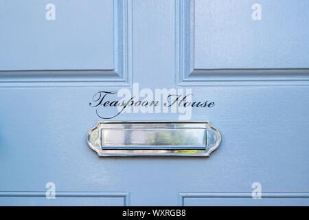 Teaspoon house writing on a blue house door in the the cotswold village of Little Comberton, Cotswolds, Worcestershire, England Stock Photo