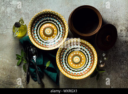 empty plates on a table set for guests. plates and cutlery. dinner or lunch styling Stock Photo
