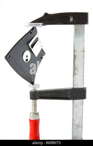 Diskette caught in carpentry clamps on a white background Stock Photo
