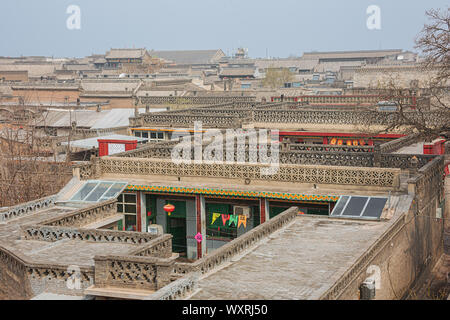 Walking past the tiled roofs in the old town of Pingyao seen from the city wall Stock Photo