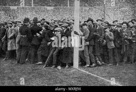 The Wembley Cup Final, 1923. Crowds overflowed on to the field, before the match between Bolton Wanderers and West Ham. The 1923 FA Cup Final was an association football match between Bolton Wanderers and West Ham United on 28th April 1923. The final was preceded by chaotic scenes as enormous crowds surged into the stadium. The crowd is estimated to have been as large as 300,000. Bolton Wonderers won the match 2 - 0. Stock Photo