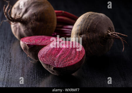 Tasty raw beetroot. Sliced beetroot on black kitchen table. Stock Photo