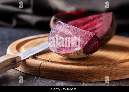 Tasty raw beetroot. Sliced beetroot on cutting board. Stock Photo