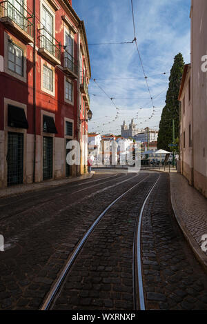 Street near the Miradouro das Portas do Sol viewpoint and view of Igreja de Sao Vicente de Fora church and old buildings in Alfama and Graca in Lisbon Stock Photo