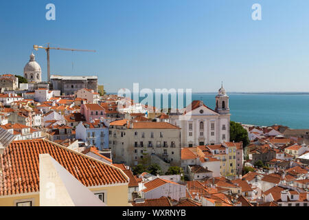 View of Tagus River and old buildings at the historical Alfama district in downtown Lisbon, Portugal. Viewed from Miradouro de Santa Luzia  viewpoint. Stock Photo