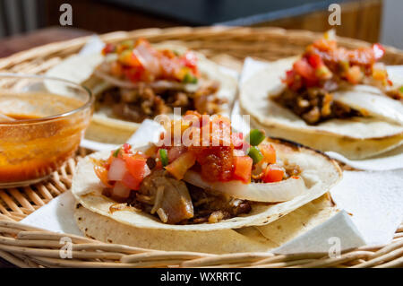 Mexican carnitas tacos, slow cooked pulled pork, traditionally from the state of Michoacán and made famous by the towns of Quiroga and Uruapan. Served Stock Photo