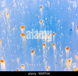 Background of an old wall covered in blue paint. Rusty metal surface. Grunge texture. Stock Photo