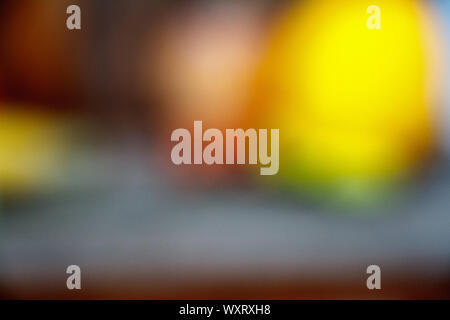 Abstract defocused round shaped orange and yellow lights on a dark backdrop Stock Photo