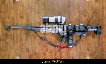 Yakima, WA, USA - August 14, 2019: Canon cameras, lenses, flashes, tripod and other equipment in the shape of an assault rifle or machine gun Stock Photo