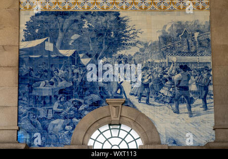 Decorative ceramic tiles surround the interior of the entrance hall of the railway station in Porto Stock Photo