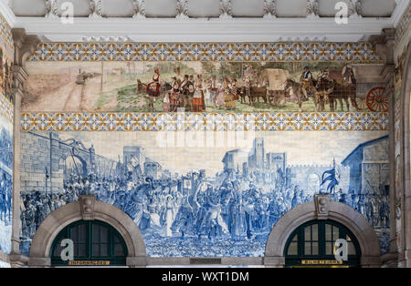 Decorative ceramic tiles surround the interior of the entrance hall of the railway station in Porto Stock Photo