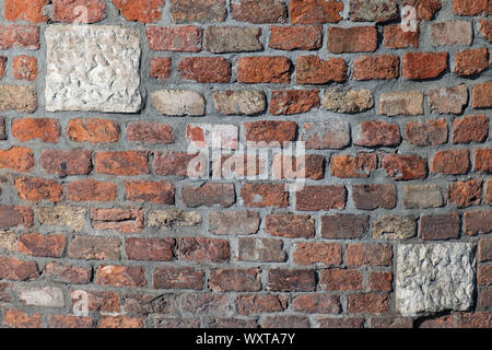 Old faded decayed brick wall pattern background Stock Photo