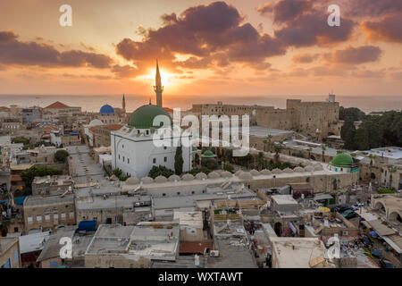 Aerial sunset view of Acco medieval old city with Al Jazzar mosque crusader and Ottoman city walls, arab bazaar and orange sky Stock Photo