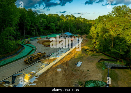 Aerial view of Maryland construction site with equipment for a new bus stop with small buildings and a shed before sunset Stock Photo