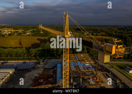 Aerial view of American construction building site with yellow crane Stock Photo