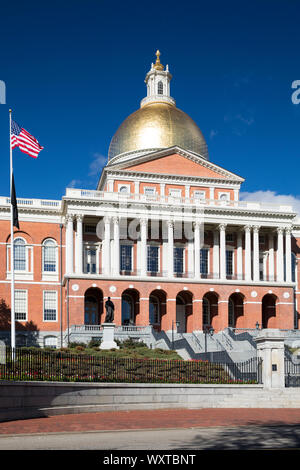 Massachusetts State House the seat of Government, with golden dome and patriotic Stars and Strips flag in the city of Boston, USA Stock Photo