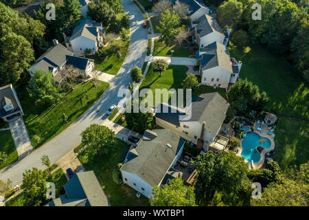 Aerial view of upper middle class neighborhood street with single family homes and pool Stock Photo