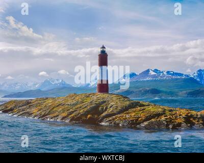 Les Eclaireurs (the scouts) Lighthouse on a small island in the Beagle Channel in Tierra del Fuego, Argentina, with the Andes mountains behind. Stock Photo